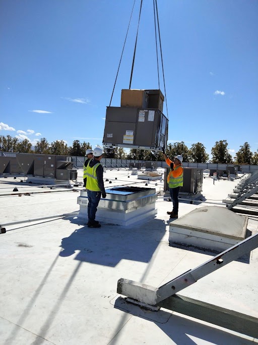 M-23 employees are installing an HVAC system.