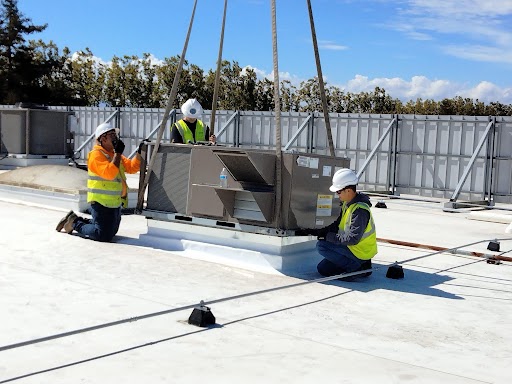 M-23 employees are installing an HVAC system.